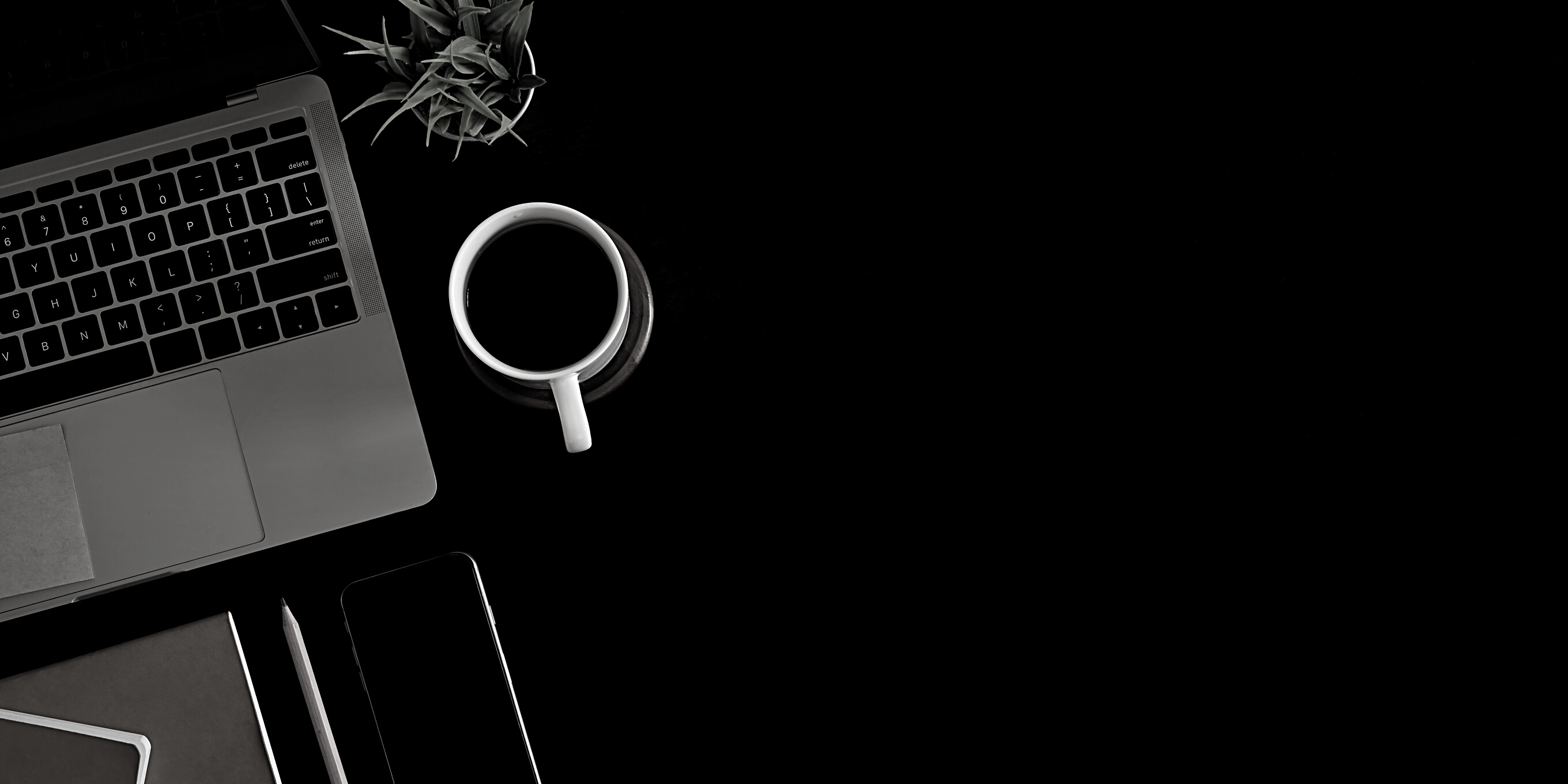 Flatlay of a Black Office Desk With a Laptop